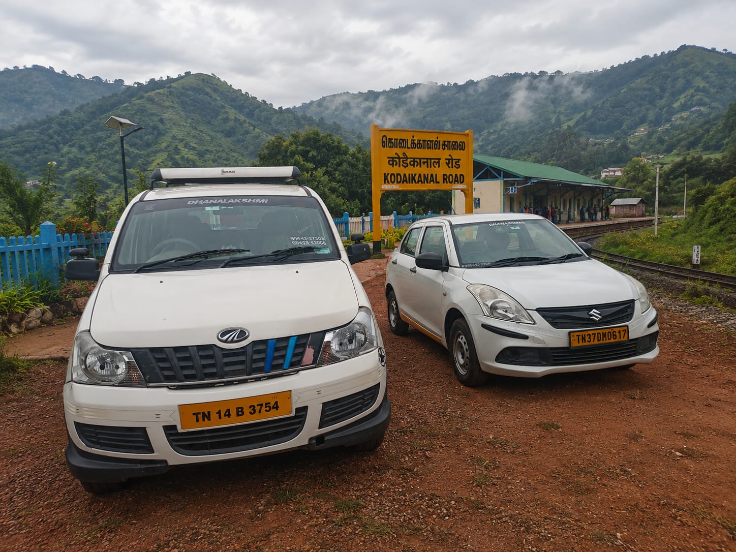 Front view of Dhanalakshmi Travels Tirupur white vehicle on the road