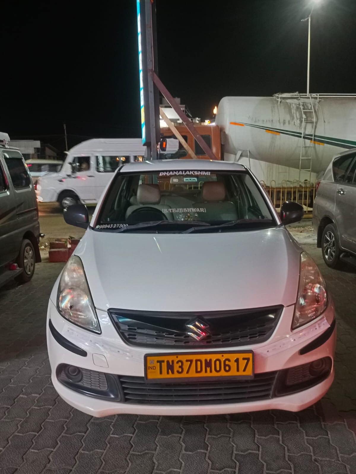 Rear window of Dhanalakshmi Travels Tirupur vehicle with contact details